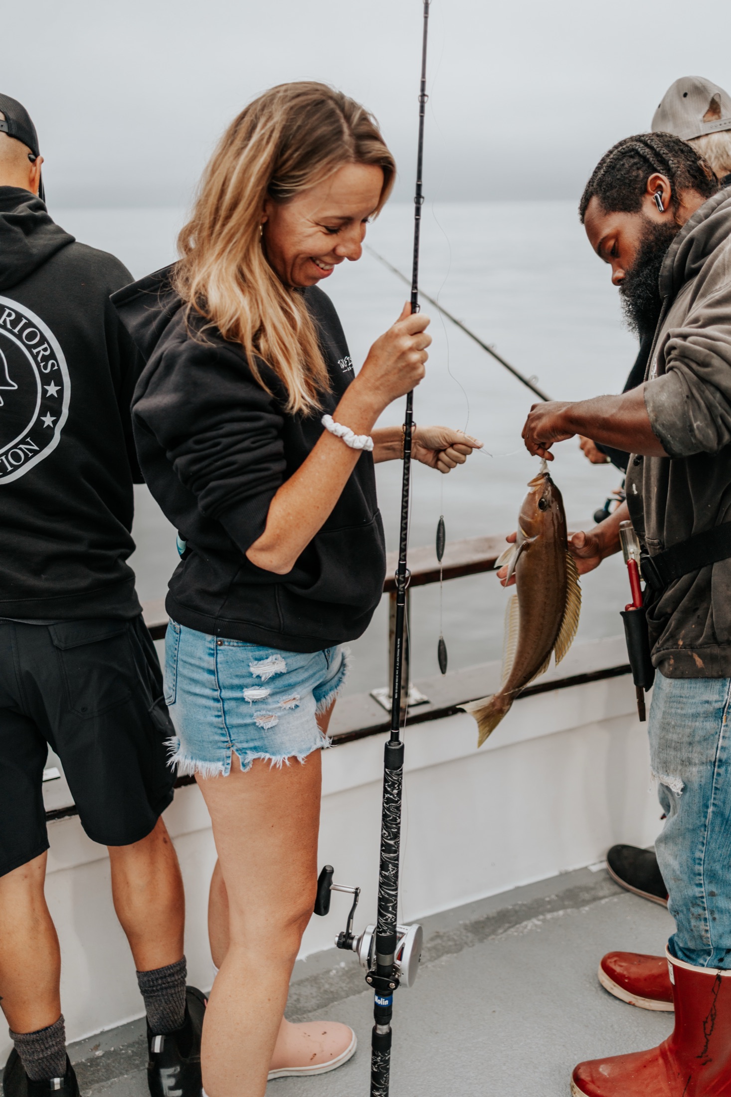 Anglers working together on the boat deck