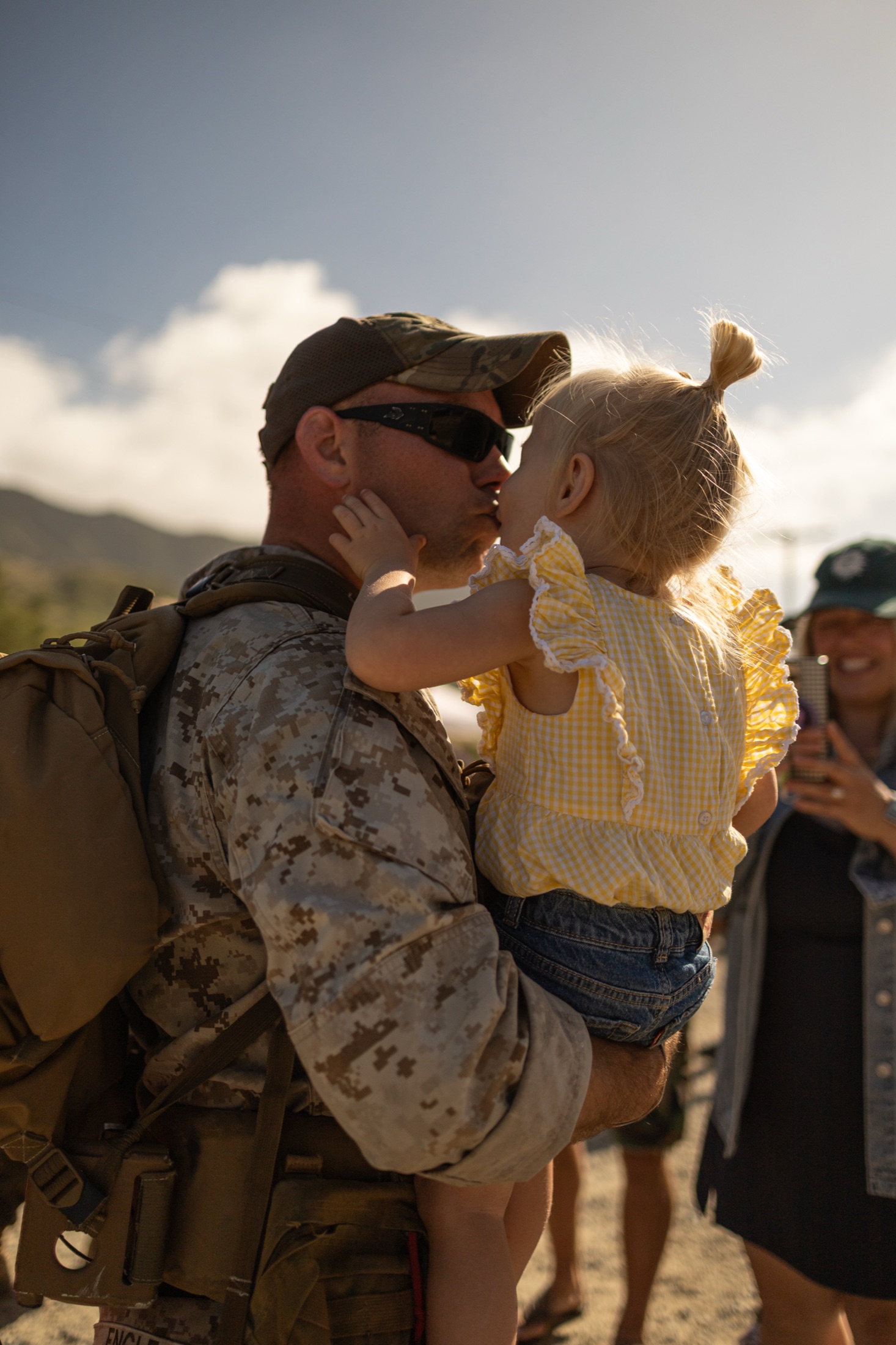 Marine greeting a child during a homecoming moment