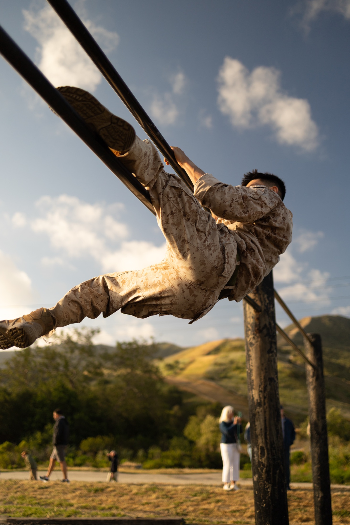 Marine crossing an outdoor training obstacle